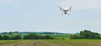 drone quad copter with high resolution digital camera on green corn field, agro